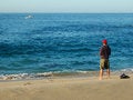 Free Man Surf Fishing On  Blue Blue Ocean Royalty Free Stock Image - 1063006