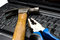 Free Hammer And Pliers On A Laptop Stock Image - 12891681
