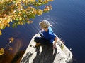 Free Girl Sits Ashore On Large Stone Stock Photography - 1347442