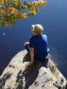 Free Girl  Sits Ashore On Large Stone Royalty Free Stock Image - 1347486
