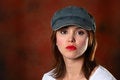 Free Brunette With Cap Red Backdrop Stock Photo - 1419020