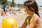 Free Little Girl Plays Ball At Crowded Seaside Royalty Free Stock Image - 15082886