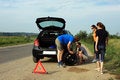 Free People Trying To Fix A Flat Tire Stock Photo - 15310350