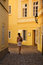 Free Girl Walking Between Yellow Buildings Royalty Free Stock Image - 1643816