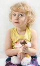 Free Little Blonde Curly Girl Eating Chocolate With Toy Stock Photo - 1837140