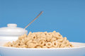 Free Oat Cereal In White Bowl With Sugar Bowl On Blue Background Royalty Free Stock Image - 1875136