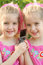 Free Twin Girls Sharing A Cell Phon Royalty Free Stock Image - 2161596