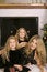 Free Mother With Twin Daughters By Fireplace Vertical Royalty Free Stock Image - 3827176