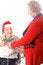 Free Elderly Man In Wheelchair Giving Wife A Present Stock Images - 3883504