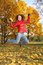 Free Girl In Red Jacket Jumps In Park Stock Photo - 3907150