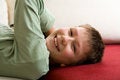 Free Happy Teenager Lie On Red Sofa Royalty Free Stock Photography - 4331787