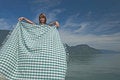Free Woman Extending A Tablecloth Stock Images - 4380594