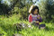 Free Girl Sitting In Grass Holding Flower Stock Images - 4657714