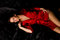 Free Girl Red Robe Black Satin Lying Down Royalty Free Stock Photos - 4717408