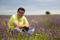 Free Man Sit In A Flower Field Stock Images - 5146534