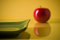 Free Fragment Of Flat Ceramic Plate And Apple On Yellow Royalty Free Stock Images - 5153509