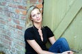 Free Happy Woman Sitting Next To Brick Building Stock Images - 5301864