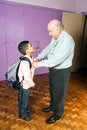 Free Grandfather Helping Grandson Leave For School Stock Photography - 5479142