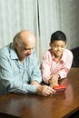 Free Grandfather And Grandson Sitting On Table - Vertic Royalty Free Stock Photography - 5479417