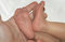 Free Leg Of The Newborn Child In Caring Hands Stock Image - 5578691