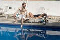 Free Man And Woman Lounging Beside A Pool - Horizontal Royalty Free Stock Photos - 5699008