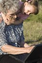 Free Grandmother And Grandchild By Notebook Stock Photography - 5716212