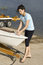Free Woman Fixing Something On Boat - Vertical Stock Photo - 5830100