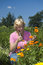 Free Elderly Woman Is Picking Flowers Stock Photography - 6123512