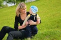 Free Mother With Baby Sit On Grass Royalty Free Stock Image - 6375586