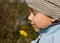 Free Boy Smelling Dandelion In Autumnal Scenery Stock Image - 6837361