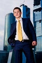 Free Friendly Businessman Standing Against Skyscraper Stock Photography - 6900492