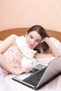 Free Girl With A Sick Throat Lays In Bed With Laptop Stock Images - 7780284