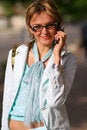 Free Young Woman Walking On The Street And Talking On The Phone Royalty Free Stock Photography - 879267