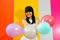 Free Young Asian Woman Holding Balloons Stock Photos - 9801133