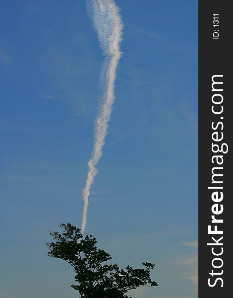 Jet stream and blue sky. This was taken in the summer of 2003. Just one of those here at the right moment things.