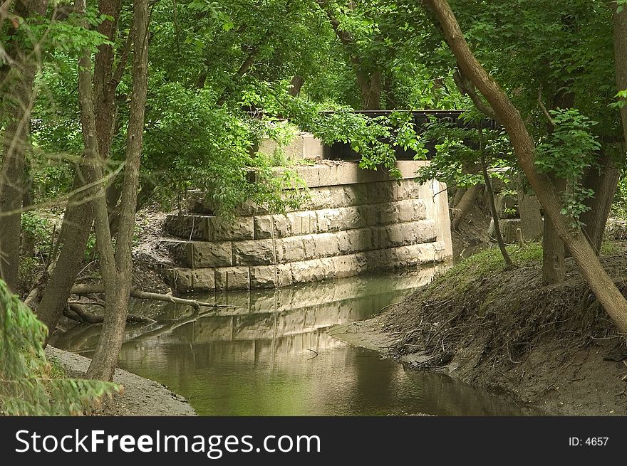 A small creek runs under a railroad bridge in the Cuyahoga Valley National Recreation Area. A small creek runs under a railroad bridge in the Cuyahoga Valley National Recreation Area