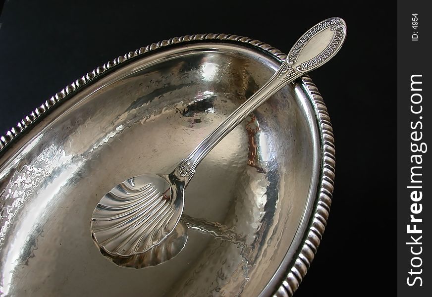 A detail of an empty silver sugar-bowl