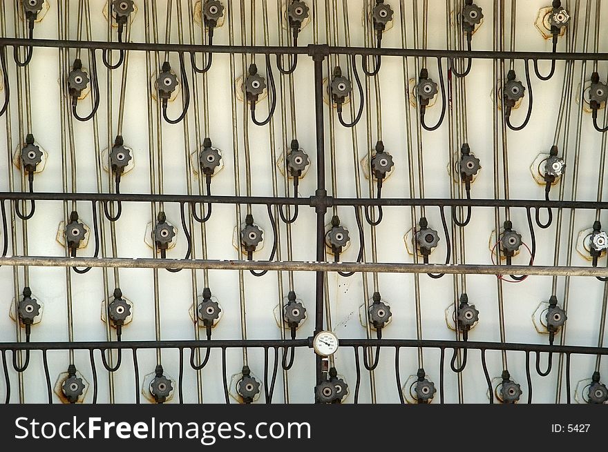 A wall of valves on a truck used to carry concentrated gases. Eack valve is at the end of one of the tubes used to store the gas. A wall of valves on a truck used to carry concentrated gases. Eack valve is at the end of one of the tubes used to store the gas.