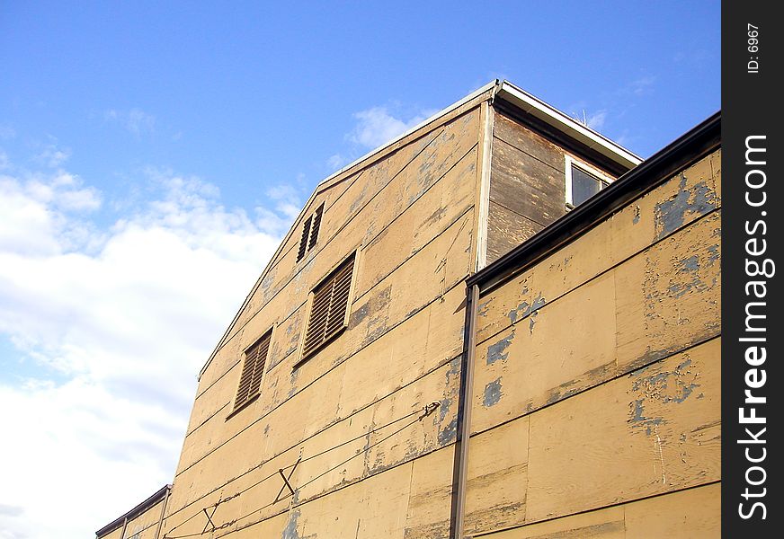 A warehouse, seemingly made of plywood, that's seen better days. A warehouse, seemingly made of plywood, that's seen better days.