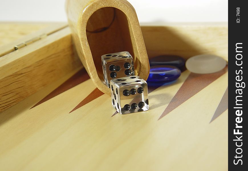 Photo of Dice and Cup on Backgammon Board - Part of Series. Photo of Dice and Cup on Backgammon Board - Part of Series