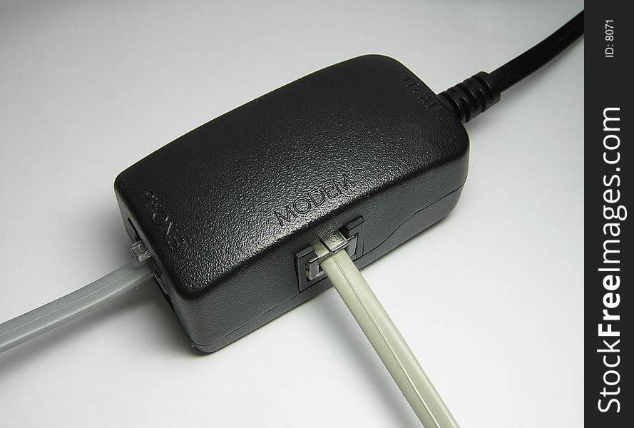 Phone line splitter for ADSL modem. Wall line is split to lines for modem and phone using RJ-11 cables.