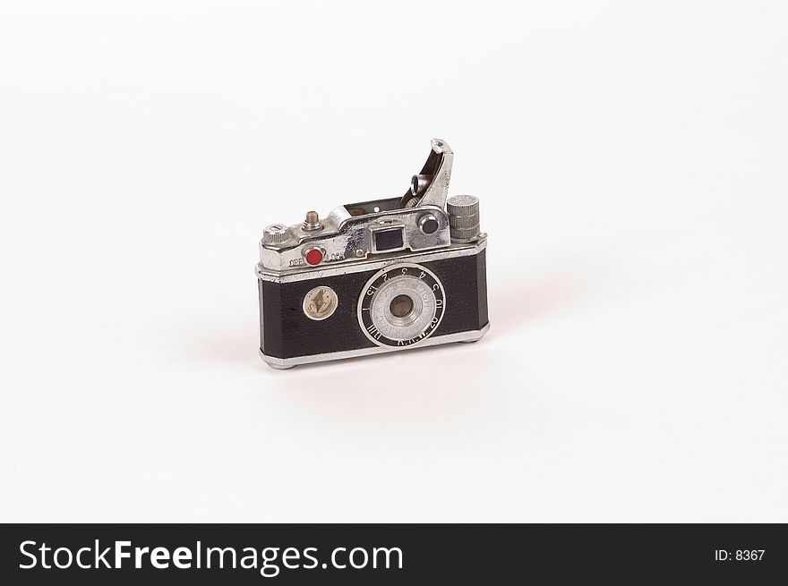 A cigarette lighter made to look like a 35mm camera, photographed on a white background. A cigarette lighter made to look like a 35mm camera, photographed on a white background