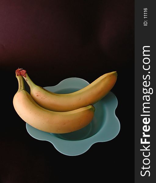 Two Bananas On A Blue Dish