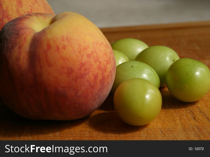 A subtle selection of garden peaches and greengages, ready for preparation. A subtle selection of garden peaches and greengages, ready for preparation.