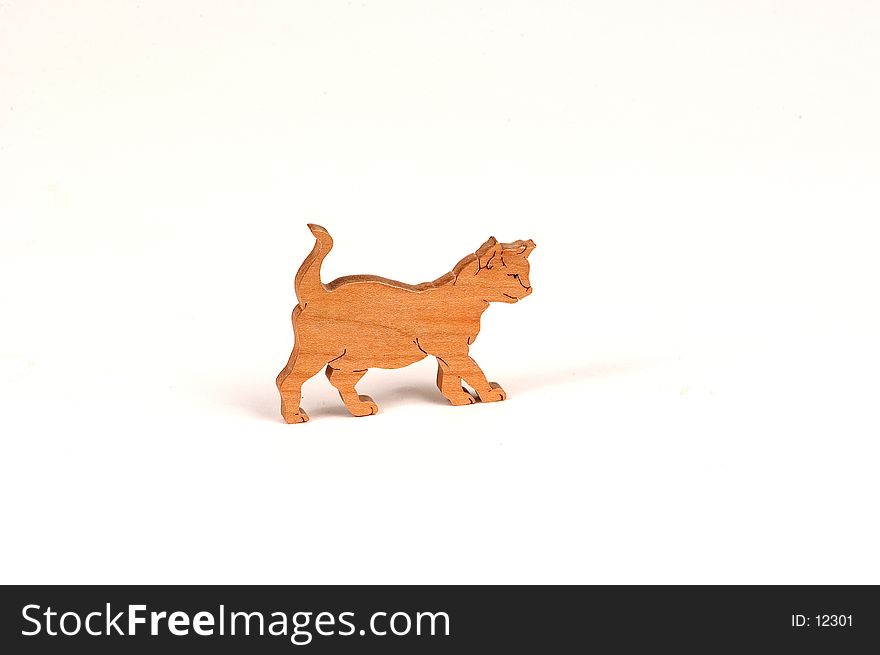 Small wooden figure of a cat walking. Small wooden figure of a cat walking.