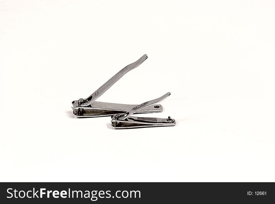 1 pair of toenail clipperts and 1 pair on fingernail clippers photographed on a white background. 1 pair of toenail clipperts and 1 pair on fingernail clippers photographed on a white background