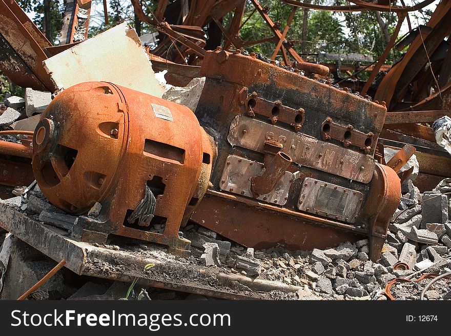 Old rusted electric motor in the rubble left after an industrial fire