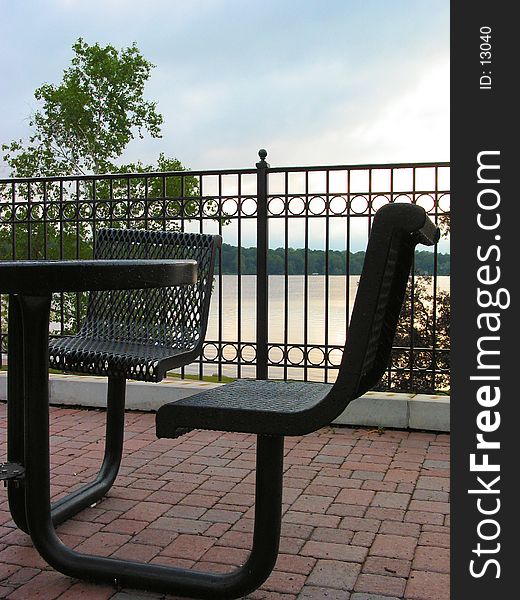 Table located in a park located near a lake. Table located in a park located near a lake.