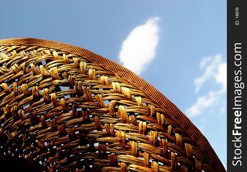 straw hat in front of cloudy sky