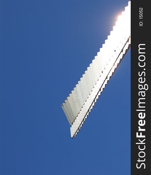 Silver windmill wing in the sunlight.